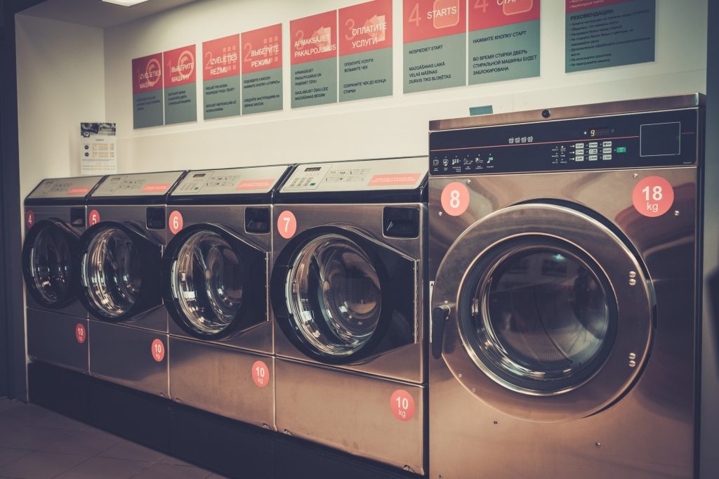 Laundry machines at laundromat shop.