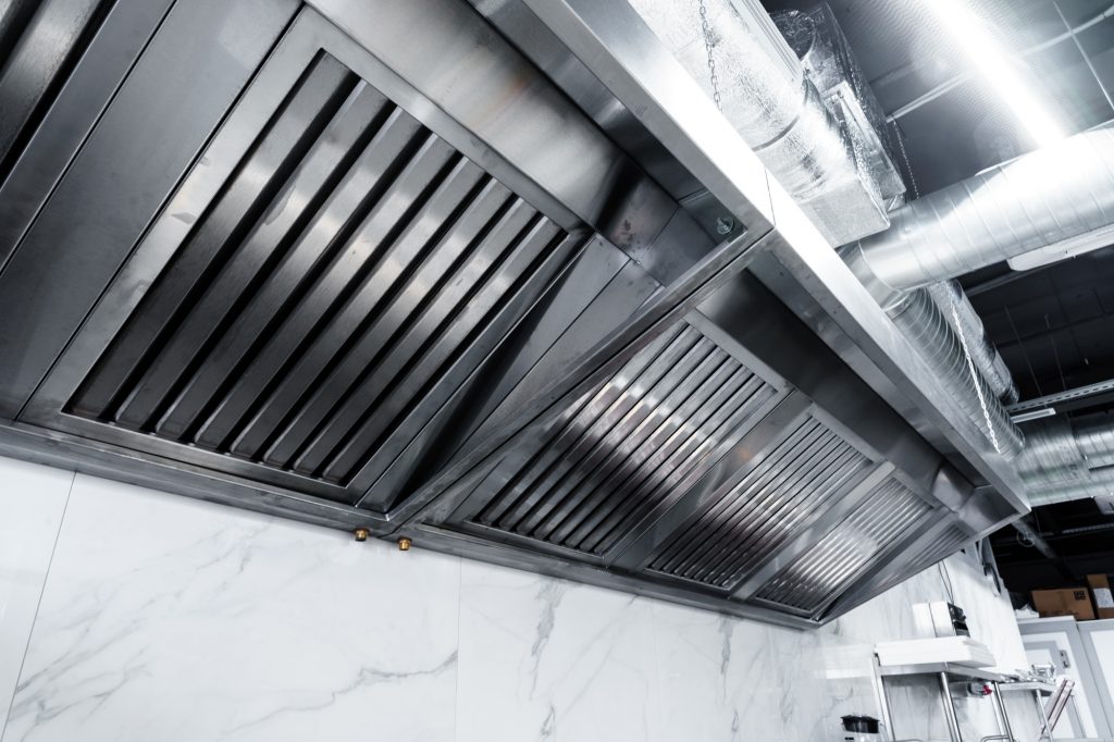 New clean stainless steel hood in professional kitchen
